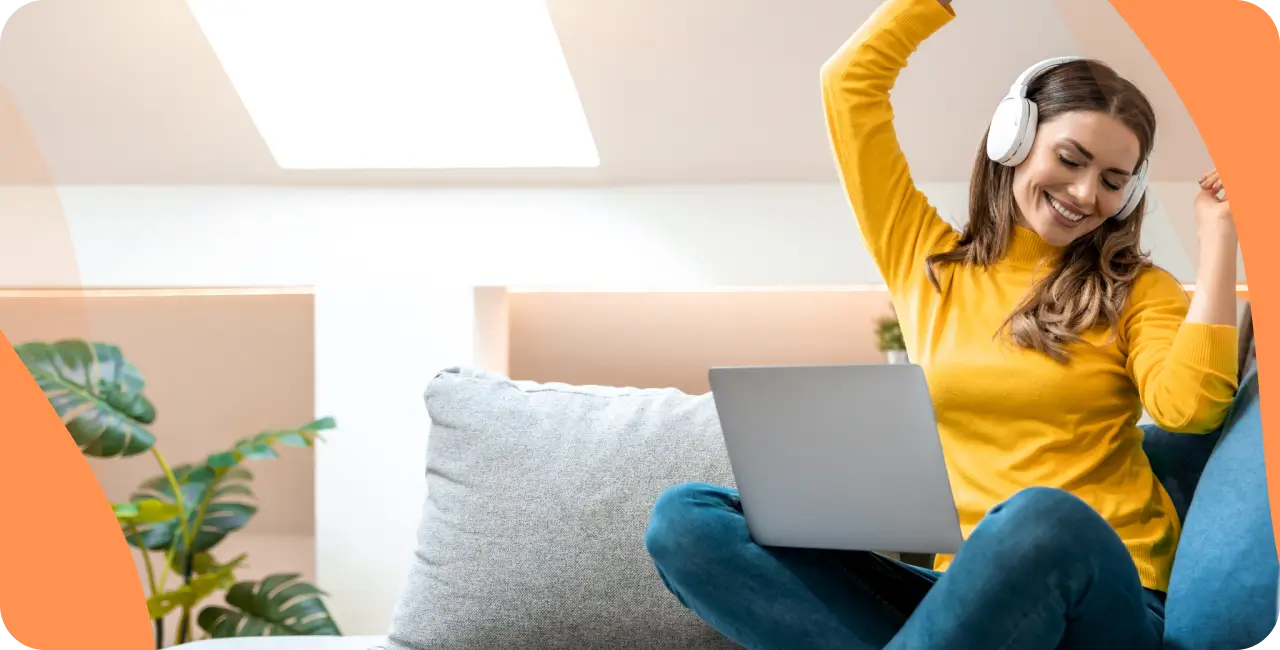 Woman listening to music on a laptop