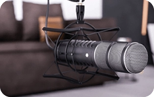 rode podcaster USB microphone on a desk