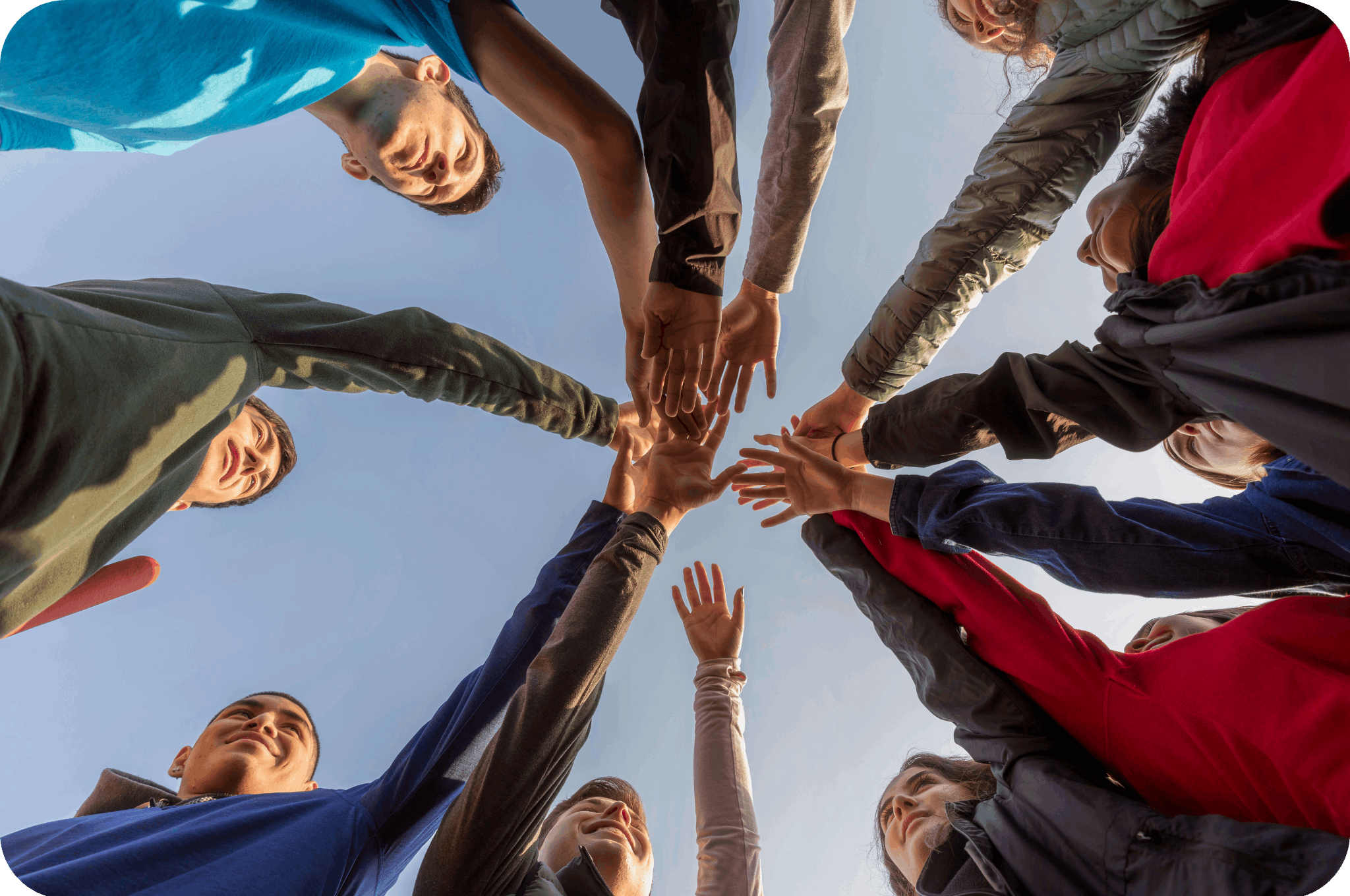 A group of people putting their hands together